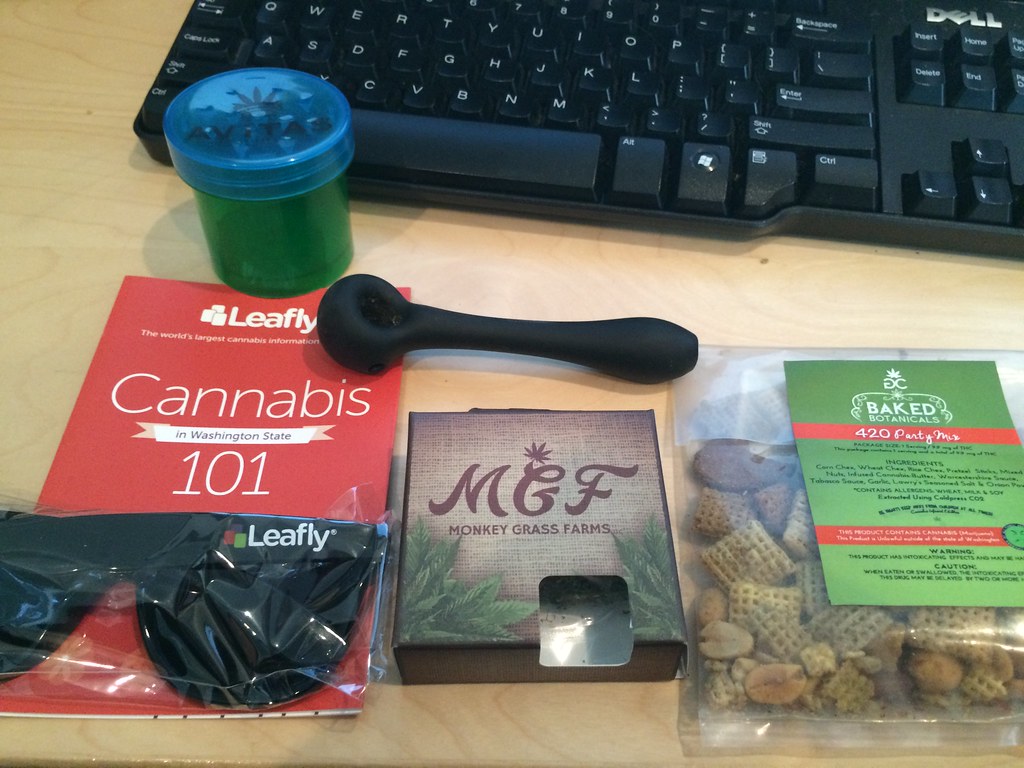 Cannabis product packaging and an educational cannabis book on a desk