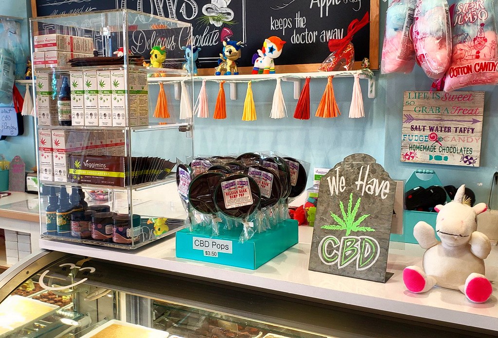 Shop counter displaying CBD products with a 'We Have CBD' sign